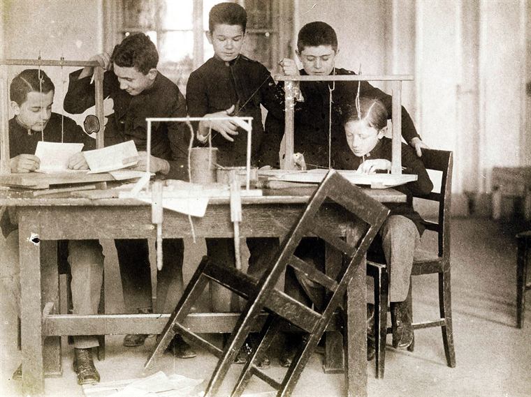 Hands folding a signature