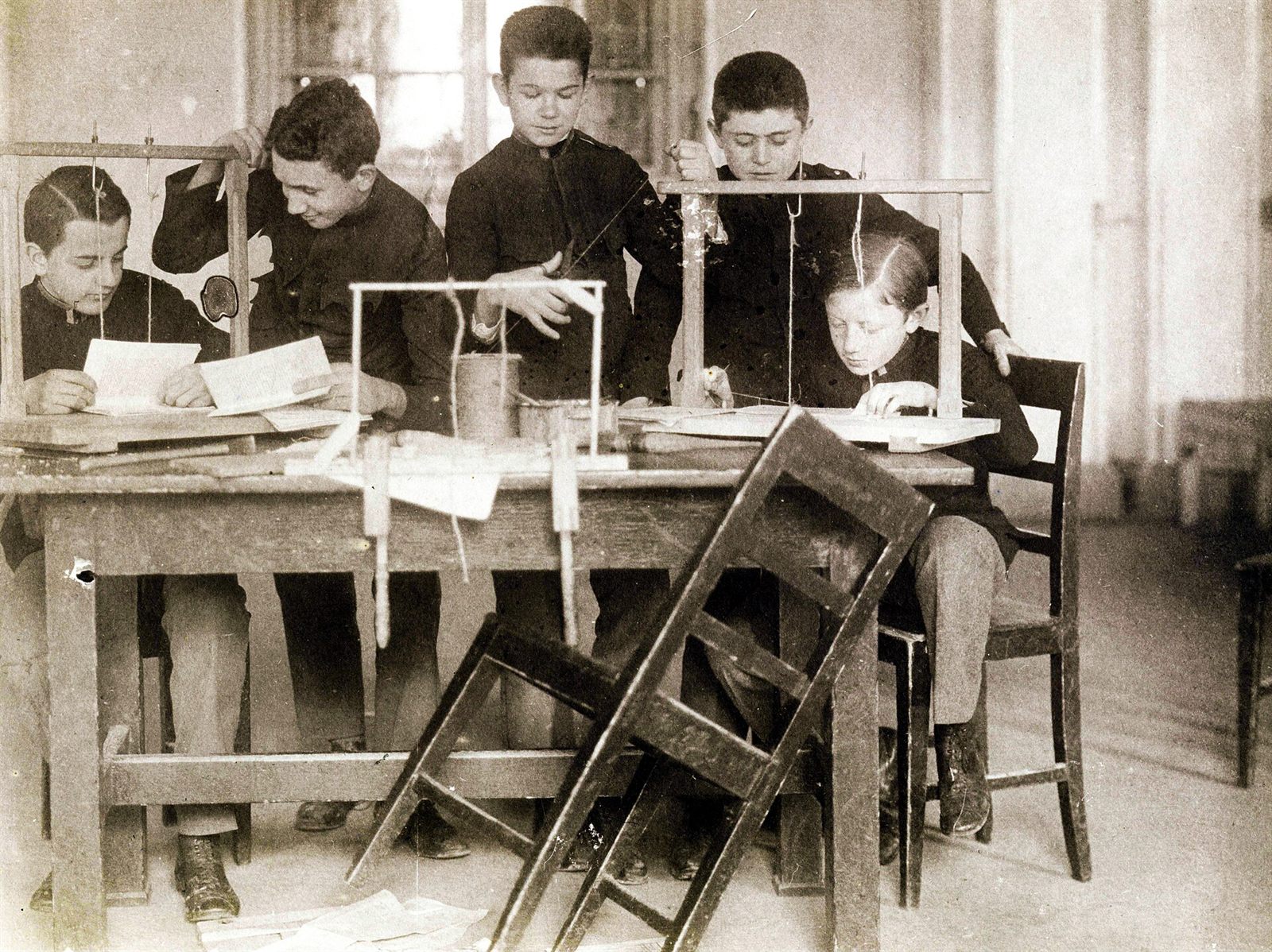 Hands folding a signature