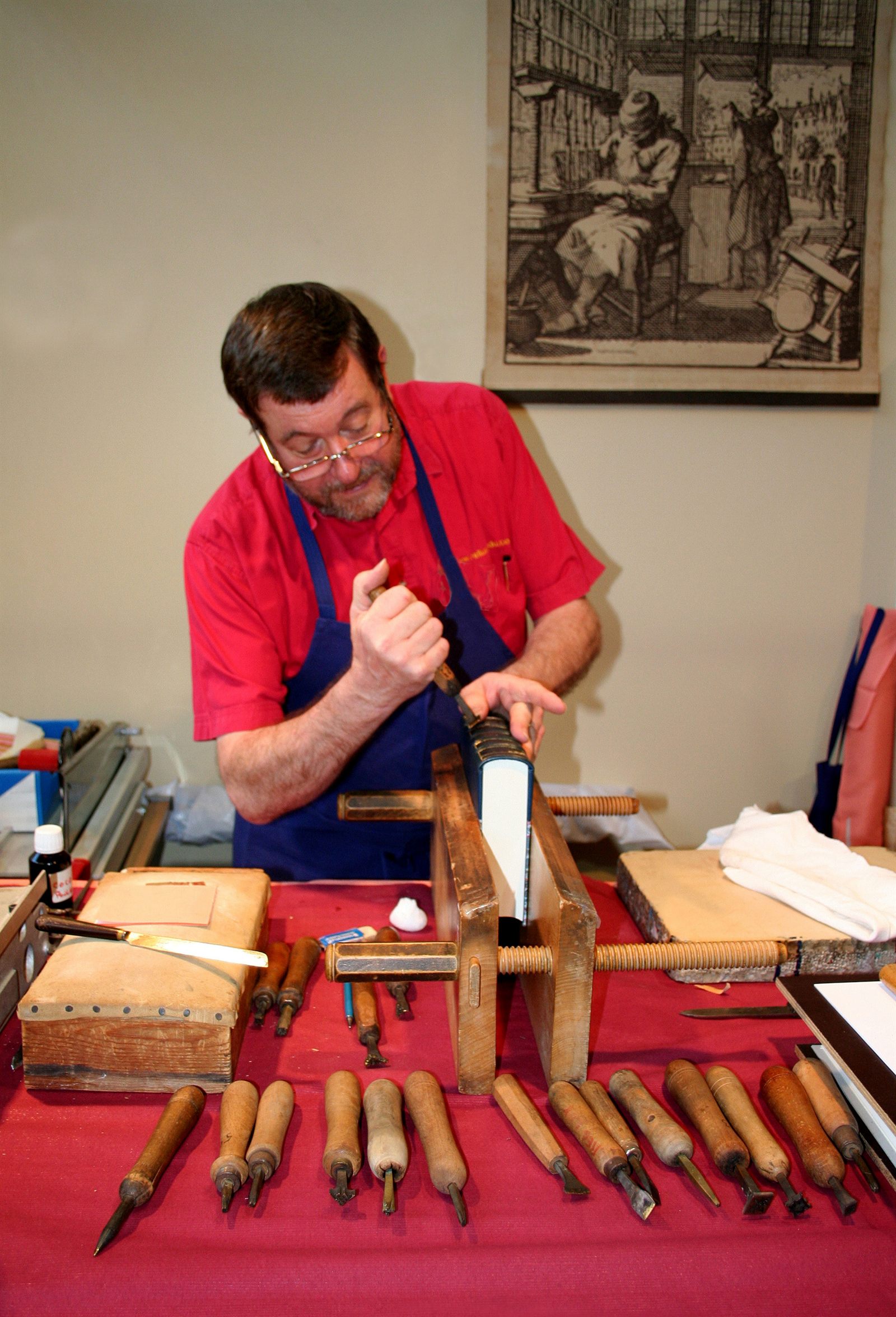 A book being sewn at the binding bench